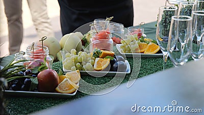 Buffet with fruits and drinks, champagne, juice. Fruit table for the holiday, Watermelon, orange and grapes. Catering Stock Photo