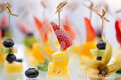 Buffet at the gala dinner. Canapes with cheese, pineapple and strawberries. Assortment of canapes. Banquet service Stock Photo