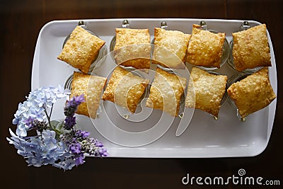 Table with snacks - portion of tasty pastries on white tray Stock Photo