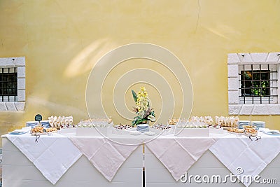 Buffet with small snacks and sandwiches stands against the wall of the building Stock Photo