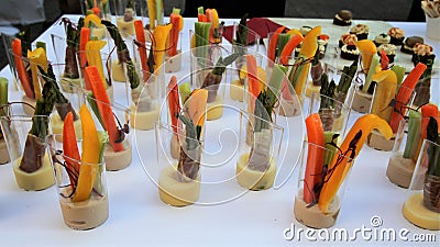 Buffet table with cut vegetable hors d`oeuvres on a white tablecloth Stock Photo