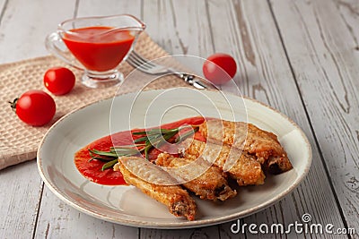 Buffolo wings with tomato sauce and rosemary sprig Stock Photo