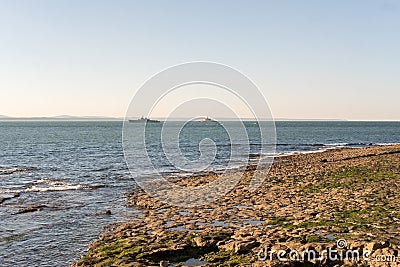 The Bugio Lighthouse and a vassal at Tagus Estuary in the morning Stock Photo