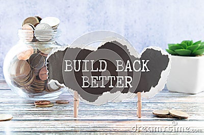 Build back better text on a notepad page on a gray background near banknotes and a magnifying glass Stock Photo