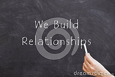 We Build Relationships on blackboard Stock Photo