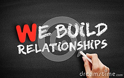 We Build Relationships text on blackboard Stock Photo