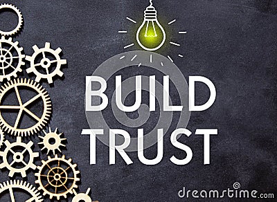 BUILD TRUST text on a notebook with calculator on diagram background Stock Photo