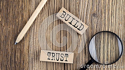 BUILD TRUST words on wooden building blocks on the wooden background Stock Photo