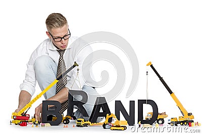 Brand start up: Businessman building brand-word. Stock Photo