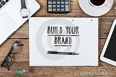 build you brand on notebook on Office desk with computer technology, high angle Stock Photo