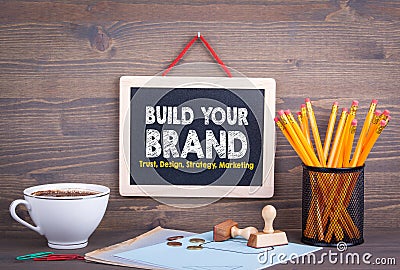 Build Your Brand concept. Trust Design Strategy Marketing. Chalkboard on a wooden background Stock Photo