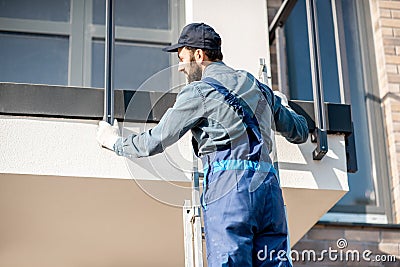 Builder mounting balcony fence Stock Photo