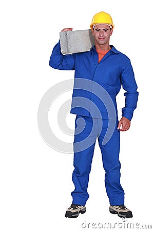 Builder carrying a block Stock Photo