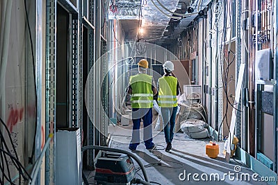 Builder and construction worker inspecting the site Stock Photo