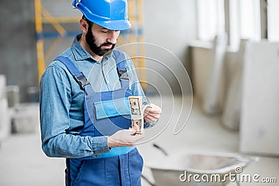 Builder with salary at the construction site Stock Photo