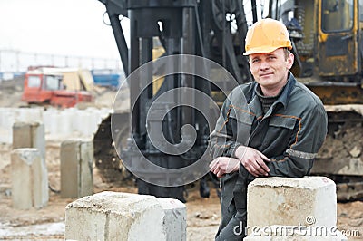 Builder in dirty workwear at construction site Stock Photo