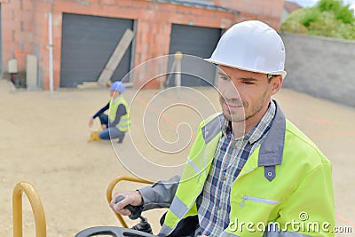 Builder driving excavator or backhoe Stock Photo