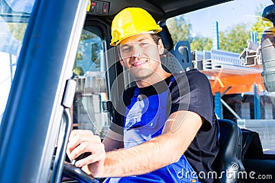 Builder driving site pallet transporter or lift fork truck Stock Photo