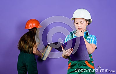 Builder engineer architect. Kid worker in hard hat. Child care development. small girls repairing together in workshop Stock Photo