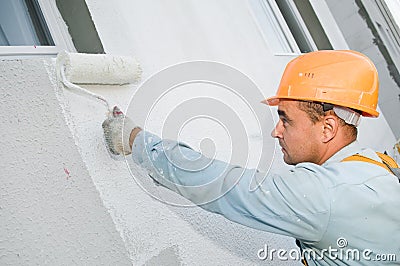 Builder facade painter at work Stock Photo