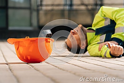 The builder fell from the construction site, broke his arm. industrial accident concept, middle Stock Photo