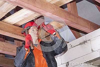 Builder hammers a nail Stock Photo