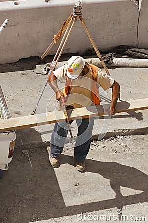 Builder with a hand saw Stock Photo