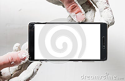 Builder hold smartphone in dirty plaster hand, pov Stock Photo