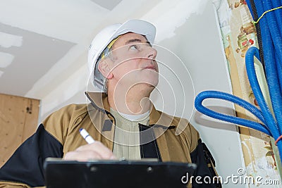 Builder inspection checking electrics Stock Photo