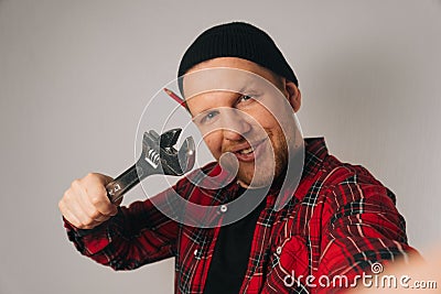 Builder is a man of Caucasian portrait as taking selfie on smartphone Stock Photo