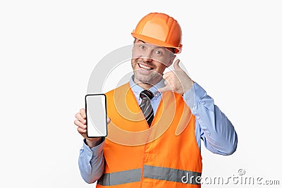 Builder Man Showing Phone Blank Screen Posing Over White Background Stock Photo