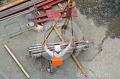 Builder manages the construction process of crane hook lifting w Stock Photo