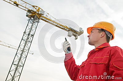 Builder operating the tower crane Stock Photo