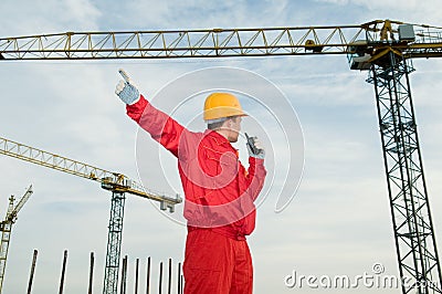 Builder operating the tower crane Stock Photo