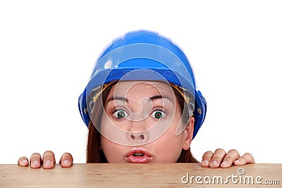 Builder peering over a ledge Stock Photo