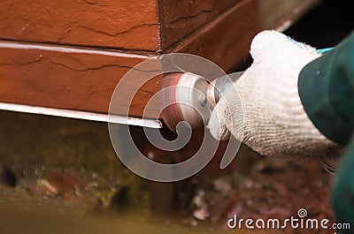 Builder polishing the red wall. House environment theme Stock Photo