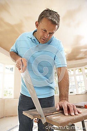 Builder Sawing Wood On Workbench Stock Photo