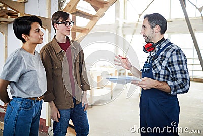 Builder talking to customers Stock Photo