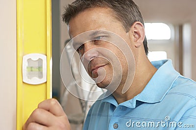 Builder Using Spirit Level Stock Photo