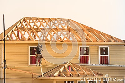 Builder on Wooden House Editorial Stock Photo