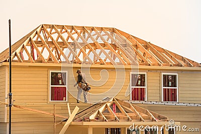 Builder on Wooden House Editorial Stock Photo