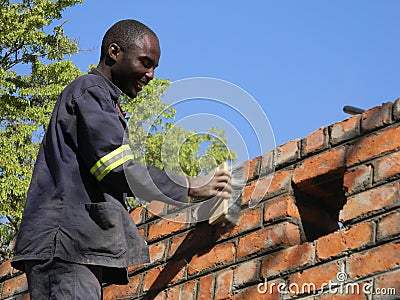 Builder at work polishing bricks. Editorial Stock Photo
