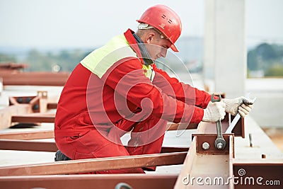 Builder worker assembling metal construction Stock Photo