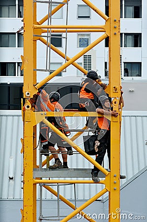 Builders assemble a construction tower crane Editorial Stock Photo