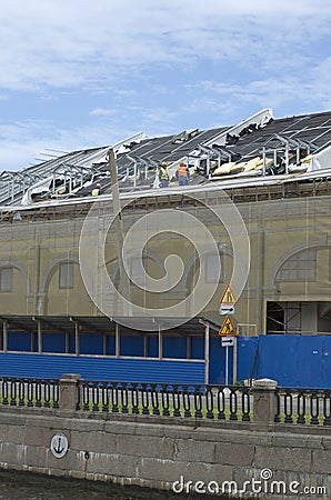 Builders assemble the roof of the building Editorial Stock Photo