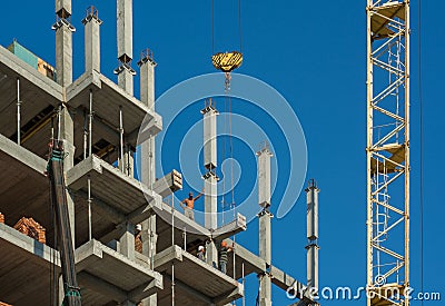 Builders with crane building multistorey house Editorial Stock Photo