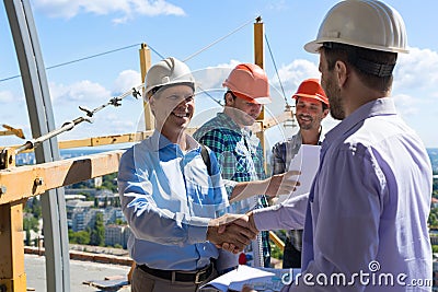 Builders Handshake, Two Happy Smiling Partners Shaking Hand After Meeting With Foreman Team On Site Stock Photo