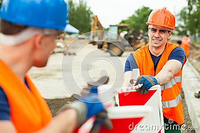 Builders working along Stock Photo