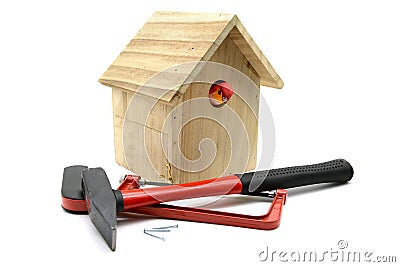 Building bird nesting box with hammer, nails and saw Stock Photo