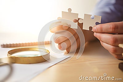 Building a business success. The hands with puzzles Stock Photo